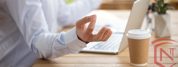 Workplace_wellness_meditation_hands_coffee_cup_laptop_shield